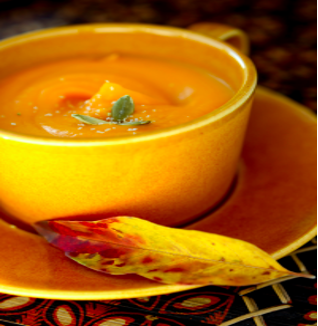 bowl of pumpkin soup on a saucer